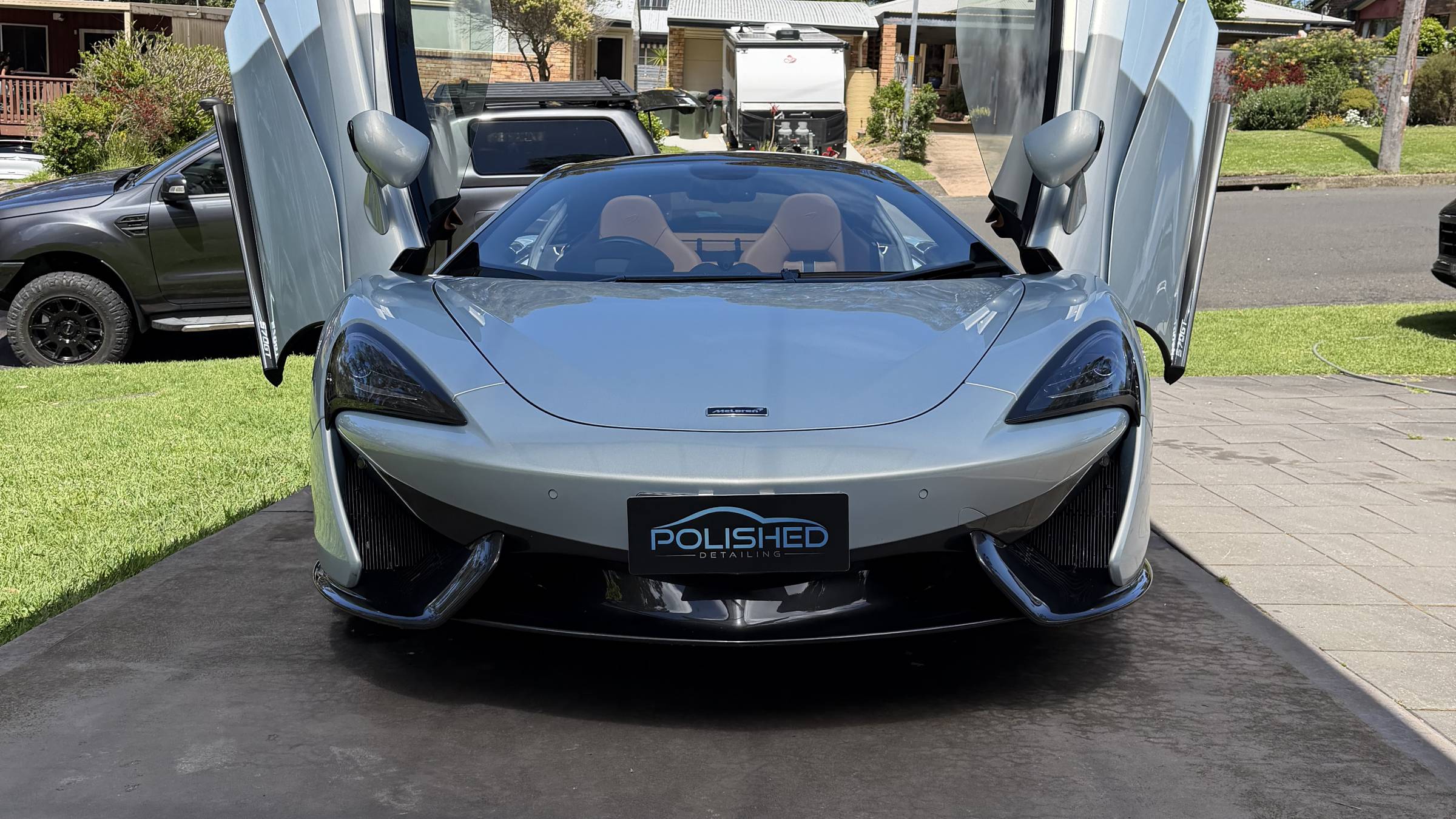 McLaren 570S front on with its doors up, freshly detailed by Polished Detailing